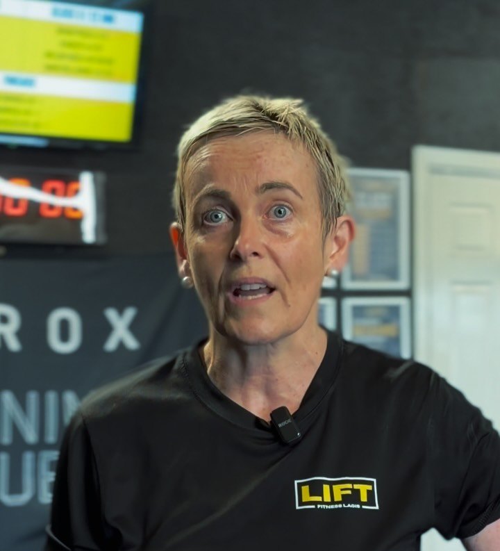 A LIFT coach wearing a LIFT tee on the studio floor